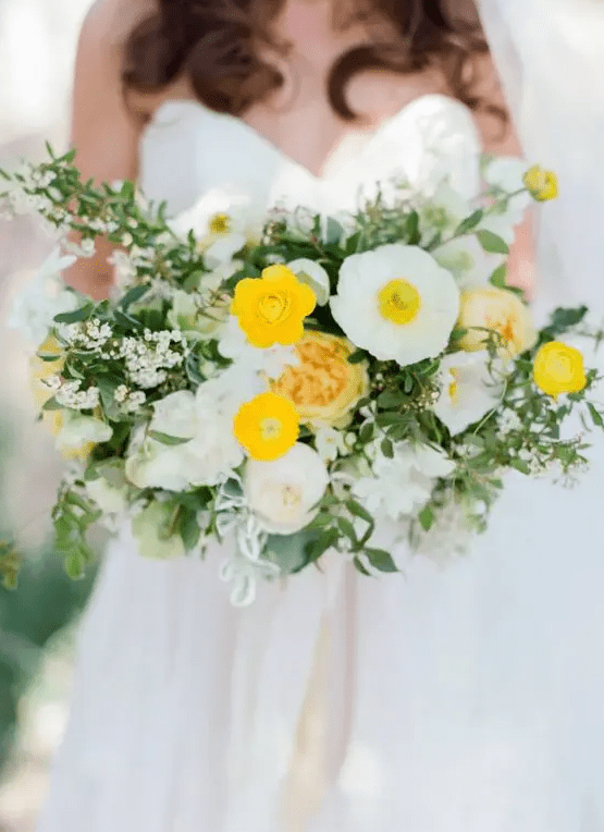 a bold wedding bouquet of white and yellow poppies, ranunculus and peonies, greenery and bouquet fillers plus long ribbon