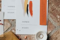 a bold wedding invitation suite in orange, yellow, grey, navy and with elegant modern letters is a chic solution