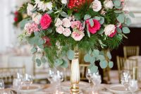 a bright and cool tall wedding centerpiece with plenty of greenery, eucalyptus and bright garden roses is perfect for a secret garden wedding
