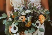 a bright wedding bouquet of yellow ranunculus, white anemones, thistles, eucalyptus is great for summer or fall