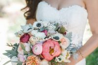 a chic and bright summer wedding bouquet of pink and blush peonies, white anemones, peony roses, pale and usual greenery and twigs