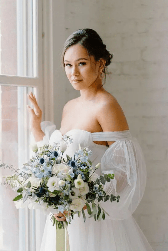 a chic and lovely wedding bouquet of white roses, blue blooms and thistles and eucalyptus is a chic and pretty idea