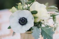 a chic anemone and rose wedding centerpiece with greenery and pale leaves is a cool and very simple idea to try