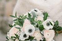 a chic spring wedding bouquet of white anemones, pink ranunculus, greenery and pale foliage is a beautiful idea
