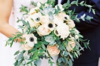 a wedding bouquet that consists of anemones and greenery