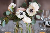a stylish cluster wedding centerpiece with vases