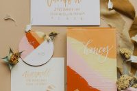 a colorful modern wedding invitation suite with bold orange, yellow, pink, red touches and gold and white calligraphy is a lovely idea for a summer wedding