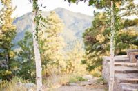 a colorful rustic wedding arch of birch branches and with greenery and super bright blooms is a lovely idea for your rustic wedding