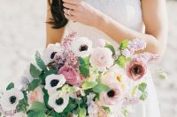 a cool spring wedding bouquet of white anemones, pink peonies and ranunculus, greenery and lilac is amazing