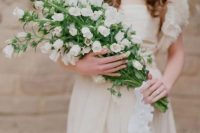 a delicate and feminine bridal look with white foxglove pokes forming a lovely long stem wedding bouquet brings wows