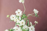 a fine art wedding centerpiece of grey vase and white blooms is a very lovely idea for a spring or summer modern wedding