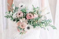 a fresh wedding bouquet of dusty pink ranunculus, white anemones and other blooms, lots of greenery for a spring bride