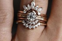 a jaw-dropping vintage stacked engagement ring with a central round one, two lower arched diamond rings and an upper large diamond arched one