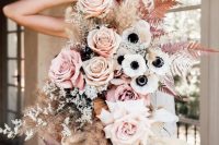 a jaw-dropping wedding bouquet of blush and peachy pink roses, white anemones, orchids, spray painted ferns and grasses