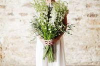 a large white bloom and greenery and grass long stem wedding bouquet is a fantastic solution for a spring or summer bride