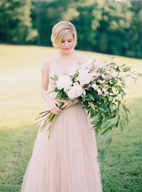 a long stem wedding bouquet with blush peonies and other blooms and greenery for a romantic and delicate spring bride