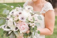 a lovely and delicate wedding bouquet of white and pink peonies, white anemones, eucalyptus and blush ribbons