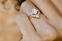a lovely stacked engagement ring with a central oval diamond and an arched diamond upper ring isn’t too much in your face