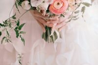 a lovely wedding bouquet of pink ranunculus, white anemones, blush peonies, greenery and thistles is amazing for spring and summer