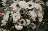 a lovely wedding bouquet of white roses, anemones, allium and eucalyptus and blue ribbons is amazing for spring or summer