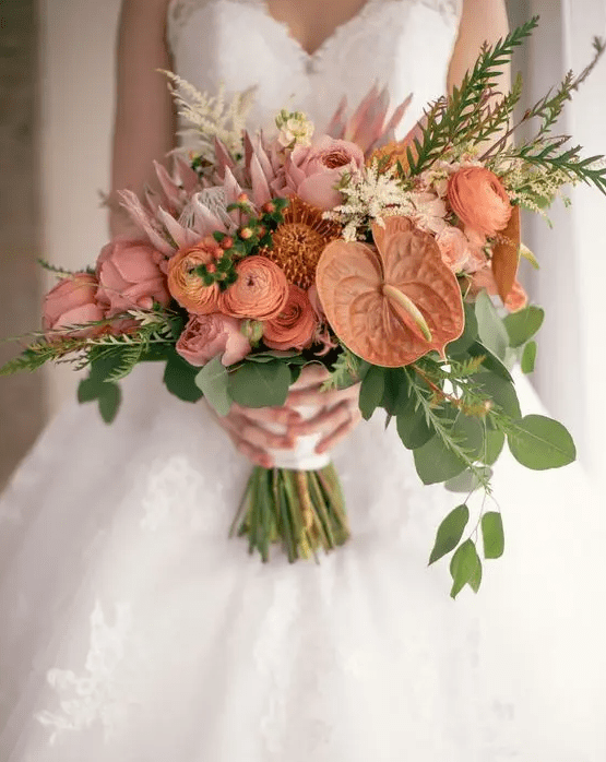 a pink wedding bouquet of peonies, raunuculus, anthurium, berries and greenery is a catchy and chic idea
