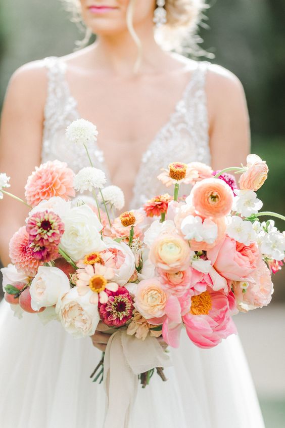 a pretty summer wedding bouquet with white peony roses, pink peonies, orange ranunculus and dahlias is amazing