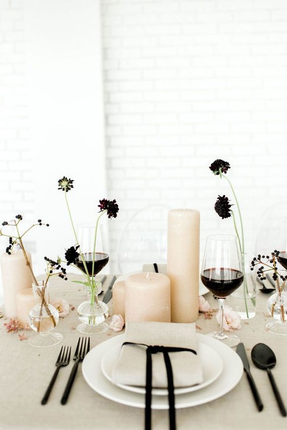 a refined cluster wedding centerpiece of dark blooms, berries, blush candles and touches of black around to echo with it