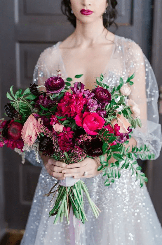 a refined jewel tone wedding bouquet with purple, hot pink, blush, deep purple blooms and foliage is amazing for the fall