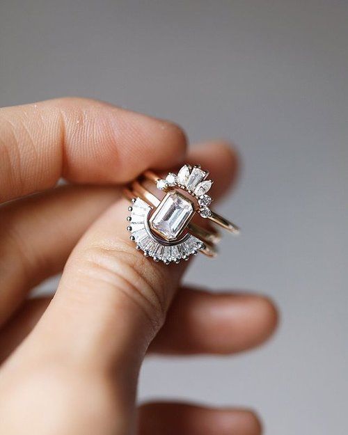 a refined vintage stacked engagement ring with a central square one and two arched diamond rings that frame it