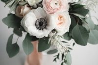 a refined wedding bouquet of blush ranunculus, white peony roses and white anemones, eucalyptus and blush ribbons is chic
