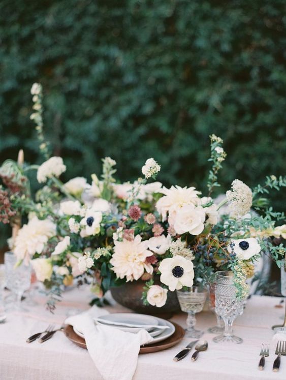 a refined wedding centerpiece of white anemones, blush and white dahlias, alllium, greenery and privet berries is a gorgeous idea for a spring or summer wedding