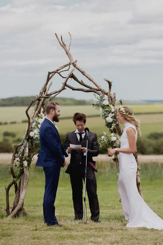 a boho wedding arch made of branches