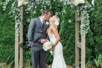a rustic wedding altar covered with eucalyptus, white hydrangeas and blush blooms is a stylish idea for a summer wedding