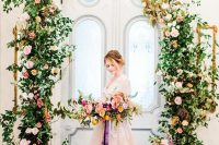 a sophisticated secret garden wedding arch of greenery, blush, orange and pink blooms is a gorgeous solution you can go for