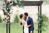 a stylish rustic wedding arch of dark wood, white, pink and burgundy blooms and greenery is a cool solution for a fall wedding