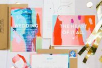 a super bold wedding invitation suite with colorful abstract patterns – red, pink, hot pink, blue, green and with styling lettering