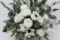 a textural wedding bouquet of white roses and peonies, white anemones and lots of textural eucalyptus looks wild