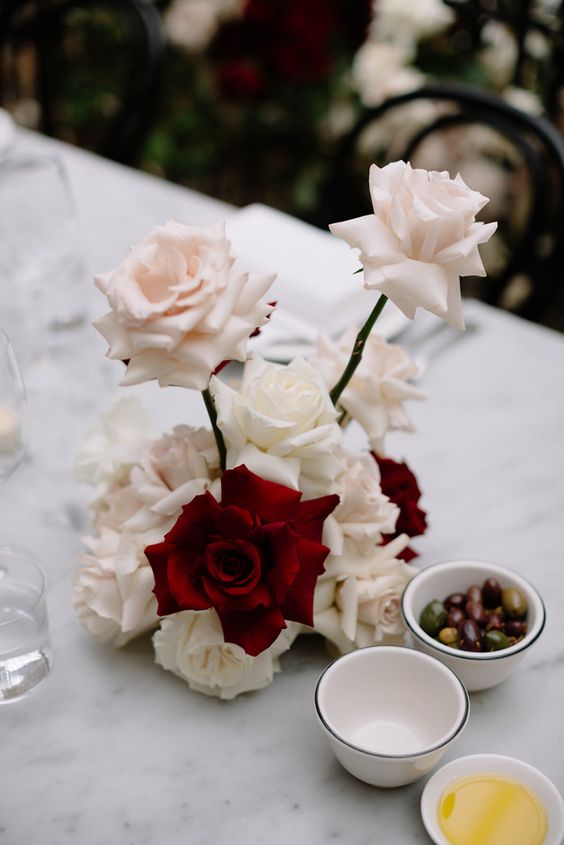 a whimsical blush and red rose wedding centerpiece is a lovely idea that will always catch an eye due to the shape and contrast