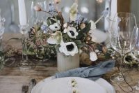 a whimsy wedding centerpiece of white anemones, blue bulbs, greenery and privet berries is a beautiful idea for a spring wedding