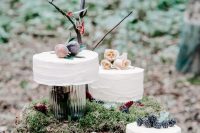 an assortment of enchanted forest wedding cakes – white buttercream ones topped with roses, fresh figs and blackberries for those who don’t want a whimsy look