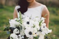 an elegant wedding bouquet of white anemones, roses, greenery and eucalyptus will fit a spring or summer wedding