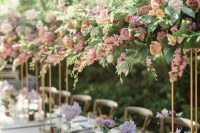 dreamy tall secret garden wedding centerpieces of blush and mauve blooms and greenery are a beautiful idea to rock