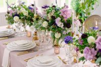 refined secret garden wedding centerpieces of white, lilac and purple blooms and greenery plus candles are amazing