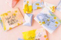 super bright abstract wedding envelopes in bold blue, yellow, pink and red, with fun patterns and black calligraphy is a bold idea