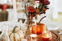 06 a bright and simple fall rustic wedding centerpiece of a wood slice with glitter, candles, pumpkins, burgundy blooms and greenery