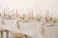 07 a delicate modern bridal shower table in neutrals, with neutral porcelain and candles, neutral blooms and greenery