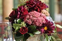 12 a simple and cute rustic fall wedding centerpiece of a tree stump, burgundy blooms of various kinds and greenery is a lush and beautiful idea