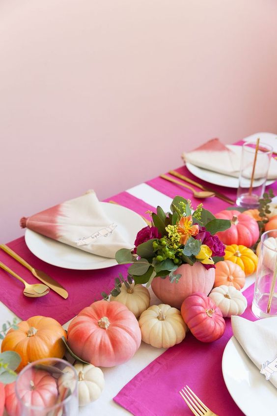 a modern colorful fall bridal shower tablescape with bright painted pumpkins, blooms and dip dye napkins