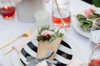 18 a pretty modern bridal shower tablescape with pink blooms and stripes plus gold cutlery, with candles and blush napkins is chic