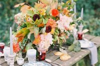 20 a chic and cool rustic fall wedding tablescape with lush and bright florals, greenery, deep purple and orange blooms, grey candles, printed plates and homemade jam as favors